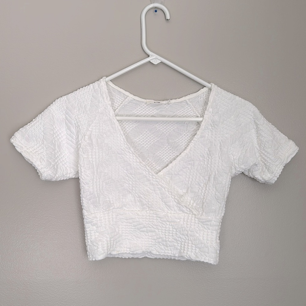 Reserved white textured wrap top
